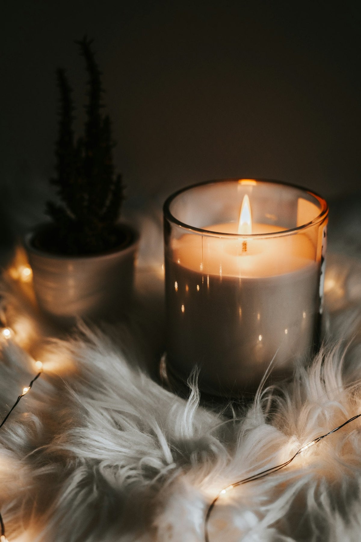 Candle glowing in a dark room