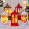 White, red and bronze Christmas scene lanterns glowing warm on a snowy surface