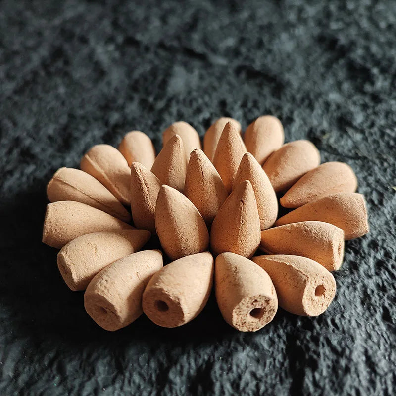 Incense cone burning on a ceramic holder