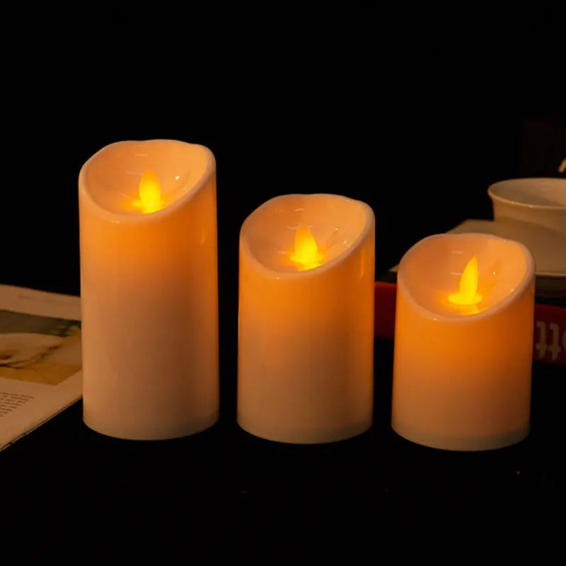 Three flameless LED candles with moving wick flames, shown lit in the dark