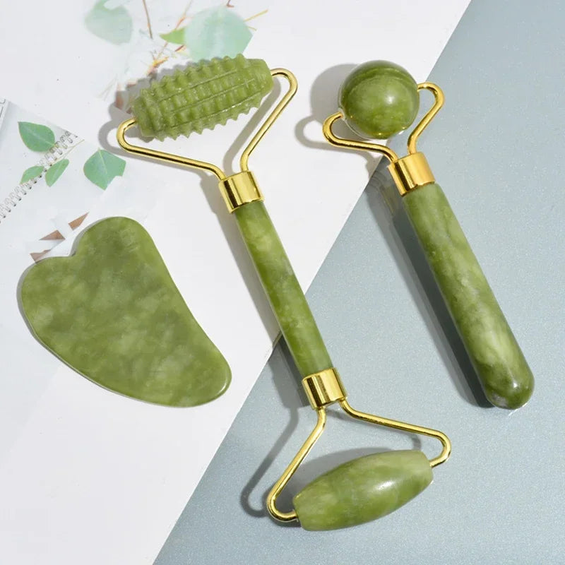 Jade roller and gua sha set arranged on a light background with eucalyptus