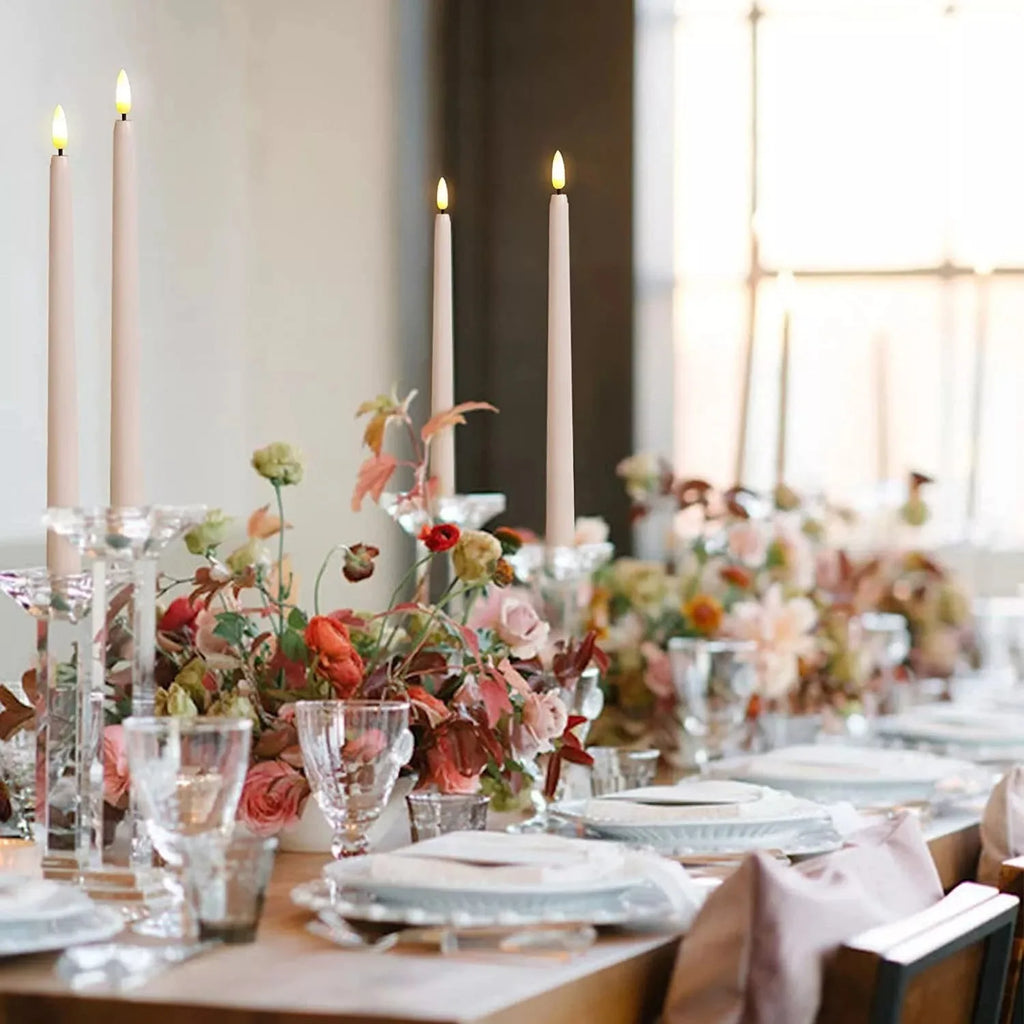 Flameless taper candles down the middle of a dinner table