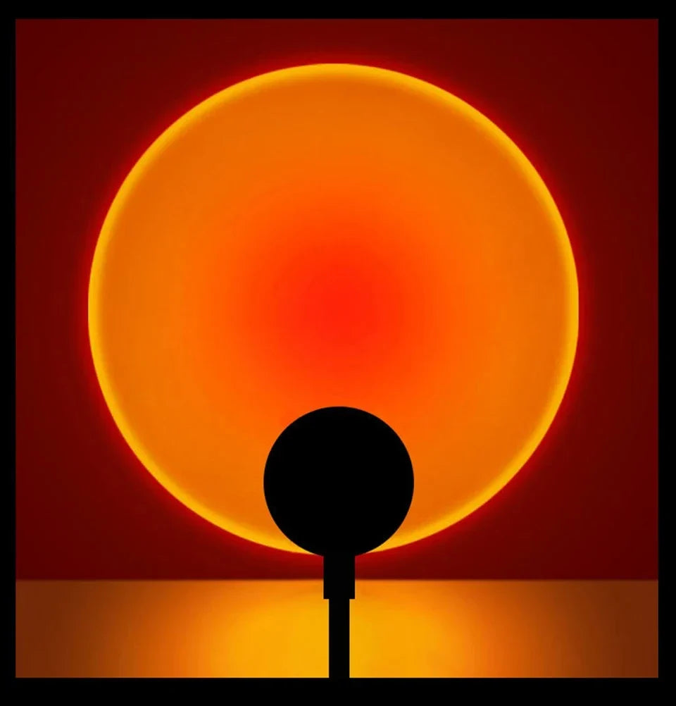 Sunset projection lamp casting a warm orange disc on a dark wall