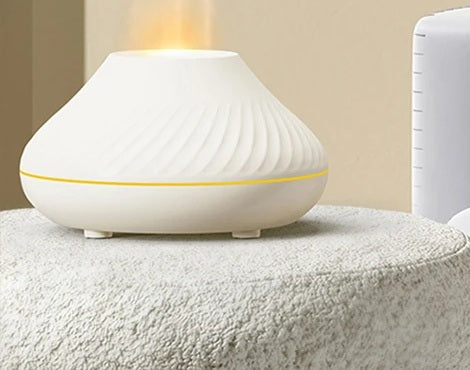 White flame aroma diffuser with warm mist on a soft stool in a living room